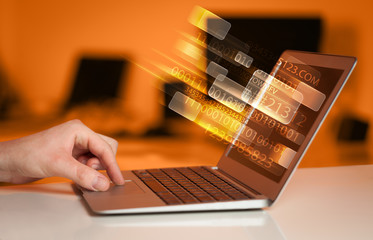 close up of man typing on laptop computer