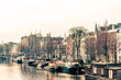 Beautiful view of Amsterdam canals with bridge and typical dutch