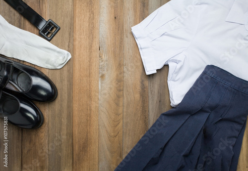 Fotografie, Obraz Still life : Thai Student girl uniform with wooden background on top view