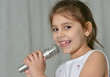Beautiful little girl with microphone