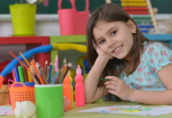 Wall Mural - Little girl drawing at home