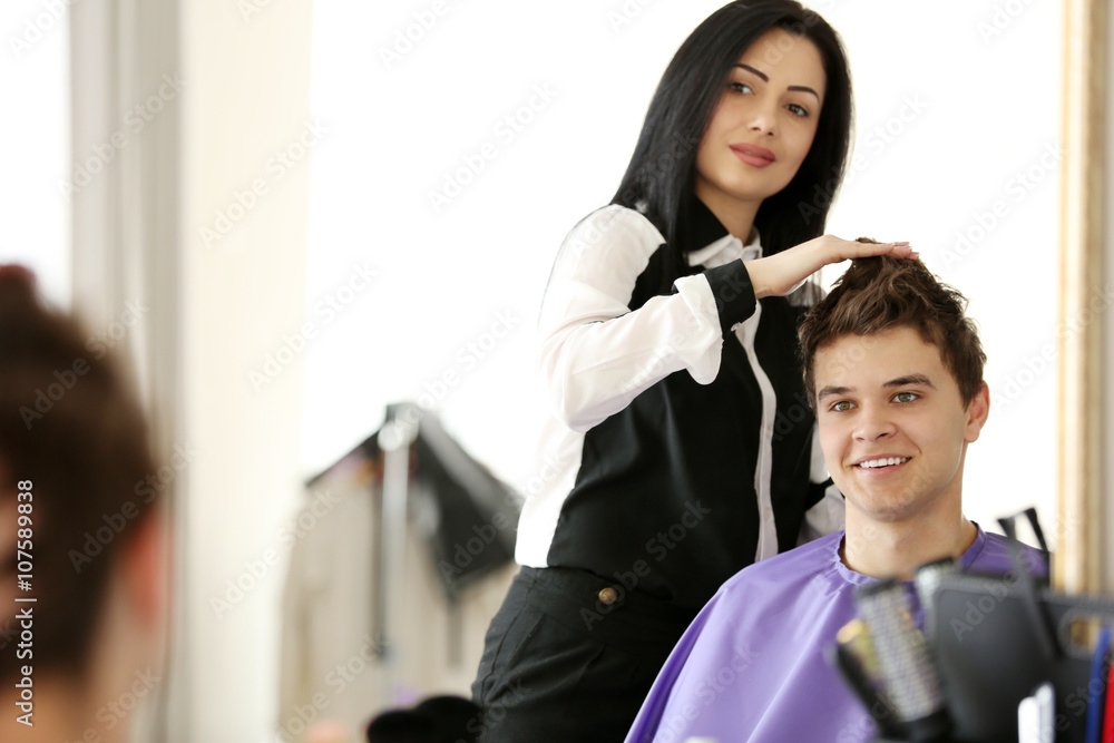 Professional hairdresser making stylish haircut