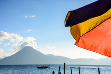Colorful Umbrella & San Pedro Volcano In Evening Light, Lake Atitlan, Guatemala