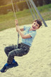 © sakkmesterke - Little boy hanging on swing rope outdoor