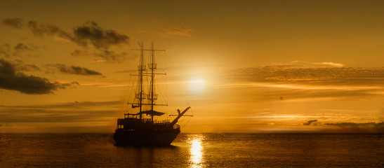 Panoramic image of the ship on a sunset background