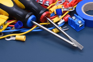 Electrical component kit to use in electrical installations on blue metal background