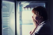 © gmstockstudio - shocked woman looking into refrigerator