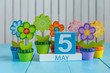 May 5th. Image of may 5 wooden color calendar on white background with flowers. Spring day, empty space for text. International disabled rights  Day  