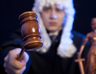 Male judge in a courtroom striking the gavel