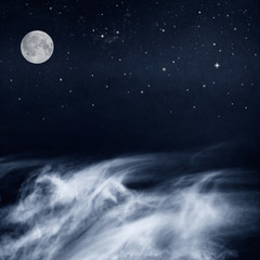 Fotobehang - Black and White Clouds and Moon with stars at night. Image has a pleasing paper grain and texture when viewed at 100 percent.