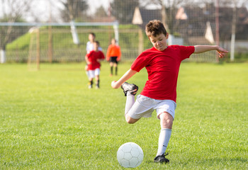 Wall Mural -  Boys kicking ball