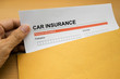 © Noey smiley - Car Insurance application form on brown envelope