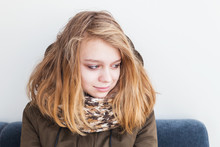 Teenage Girl In Warm Scarf Over White Wall