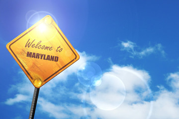 Yellow road sign with a blue sky and white clouds: Welcome to ma