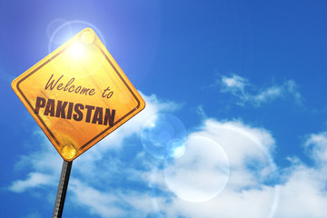 Yellow road sign with a blue sky and white clouds: Welcome to pa