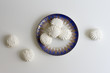 Top view of Latvian marshmallovs - zefiri on porcelain plate white background