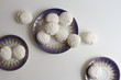 Top view of Latvian marshmallovs - zefiri on porcelain plates on white background