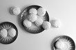 Black and white image of Latvian marshmallovs - zefiri on porcelain plates on white background