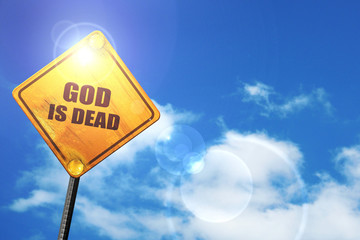 Yellow road sign with a blue sky and white clouds: god is dead