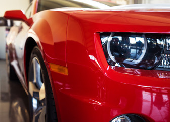 Varna, Bulgaria - Circa December 2015: New red Chevrolet Camaro SS. Front close-up. Showroom 'Perfect Auto'.