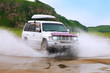 © yo camon - Mitsubishi Pajero moving by water making lots of splashes