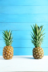 Ripe pineapples on a white wooden table