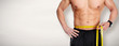 Man abdomen with measuring tape over blue background.