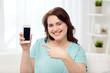 © Syda Productions - happy plus size woman with smartphone at home