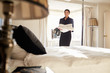 Chambermaid carrying linen in hotel bedroom, low angle view