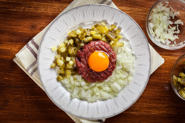 Canvas Print - Steak tartare with egg yolk, onions and pickles