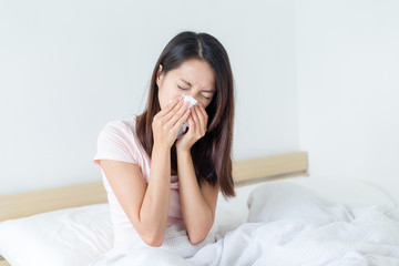 Wall Mural - Woman sneeze on bed