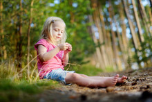 Adorable Little Girl Hiking In The Forest On Summer Day