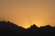 Mountain sunset with orange sky and ridge silhouette