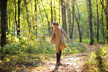 Portrait of cute child girl i in autumn park