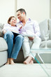 © ZoneCreative - young happy couple relax on couch at home