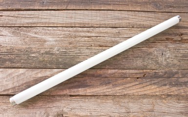 Fluorescent neon light white tube on wooden background