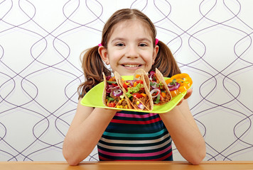 Wall Mural - happy little girl with tacos for lunch