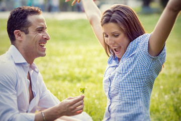 young brunette couple having fun together at the park