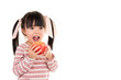 asian smiling little girl eat a apple isolated on white