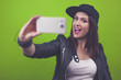 Beautiful young trendy woman with snapback-Cap and black leather