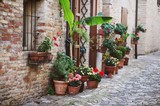 Fototapeta Uliczki - beautiful old Italian street with flowres