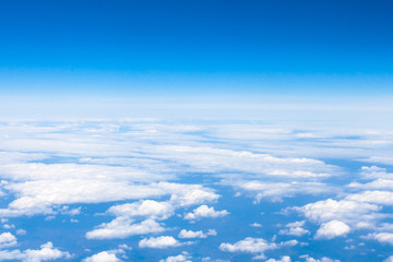Wall Mural - above view clouds and earth horizon from aircraft