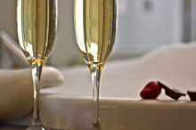 Two glasses of champagne near jacuzzi with strawberry and chocolate
