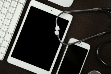 Canvas Print - Tablet, phone, keyboard and stethoscope on the table, top view