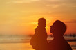 © nadezhda1906 - Father and little daughter silhouettes at sunset