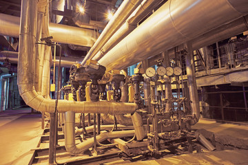 Equipment, cables and piping as found inside of a modern industr