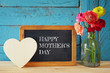 flowers next to blackboard. mother's day concept