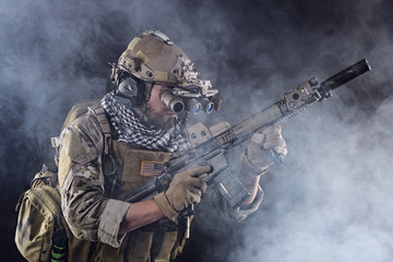 US Army Soldier in Action with goggles in the Smoke