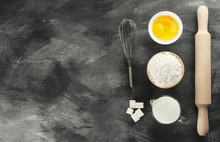 Ingredients For Pastries: Flour, Eggs, Milk Against A Dark Backg