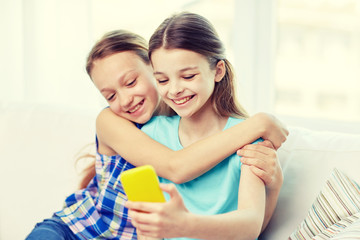 Poster - happy girls with smartphone taking selfie at home